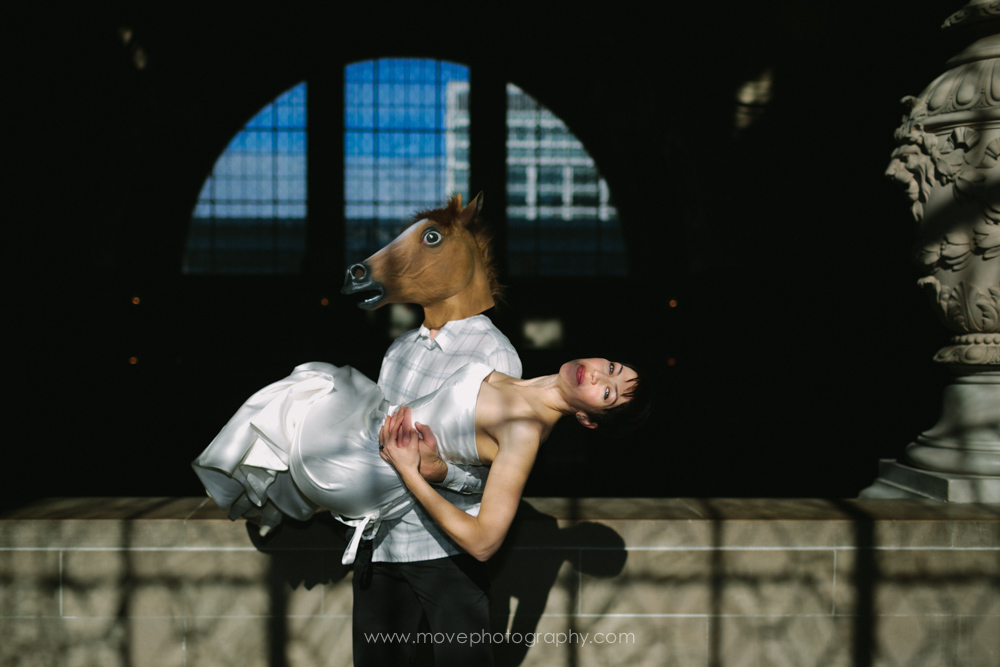 A groom with a horse mask picking up his bride at San Francisco City Hall.
