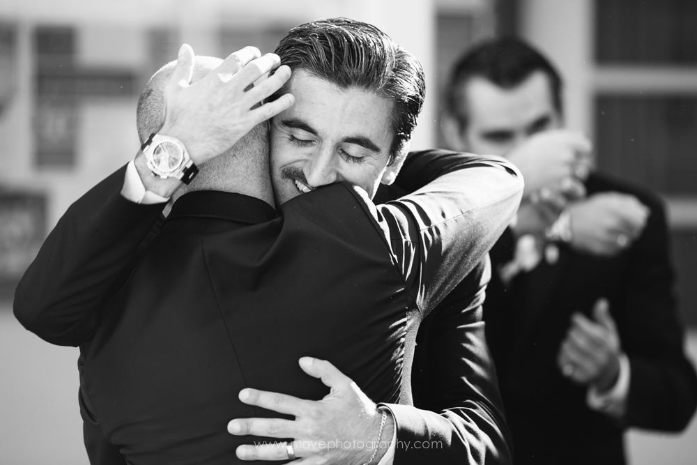 A groom embracing a relative after his St John Armenian Church wedding.