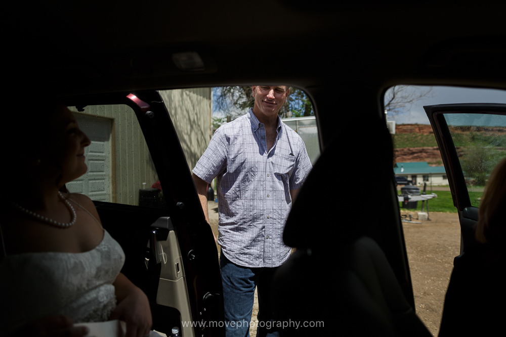 A bride leaves in a minivan for her first look as her father says goodbye. 