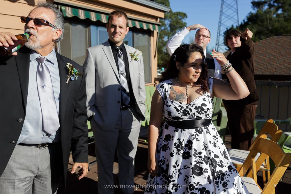 A bride, groom, and their family and friends soak up the view from the patio at their East Bay wedding reception.